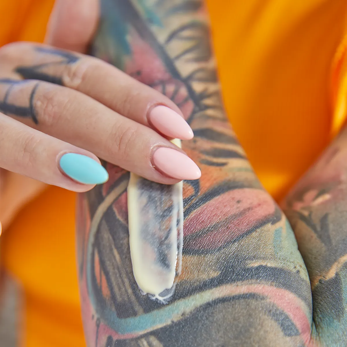 tattoo revival cream application applying tattoo lotion to prevent tattoos from fading